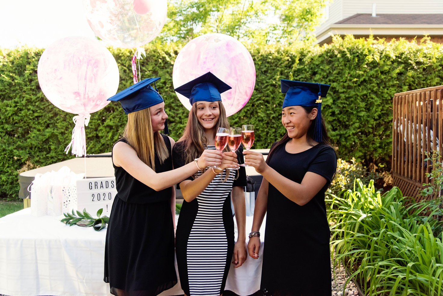 Teenage girls graduation from primary school party in backyard.