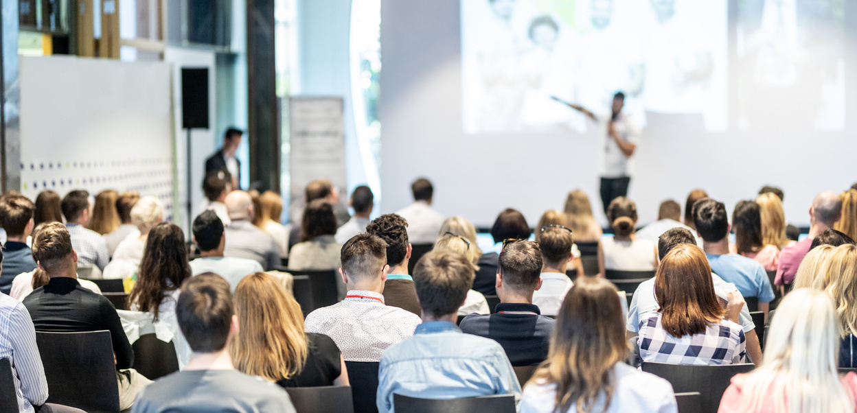 Business Speaker Giving a Talk at Business Conference Event